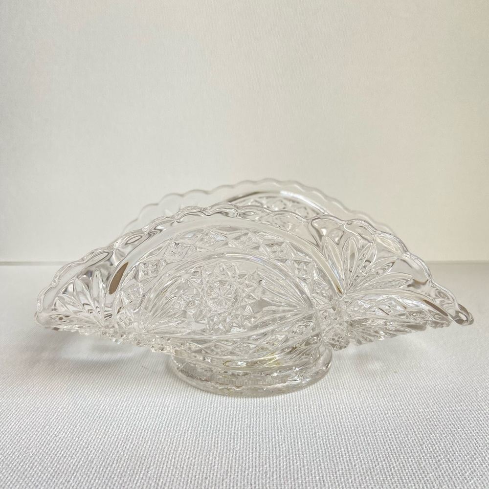 Folded fan shaped dish in pressed glass with floral design and diamond pattern